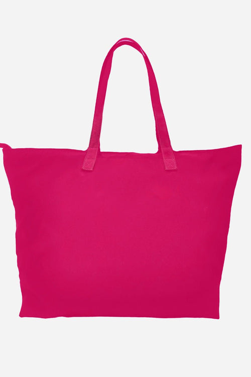Bright pink waterproof travel bag with sturdy handles and spacious interior for versatile use