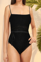 Black tan-through open back one-piece swimsuit with thin straps and waist tie detail