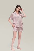 Woman wearing Mulberry Silk Essentials buttoned short set nightwear in light pink