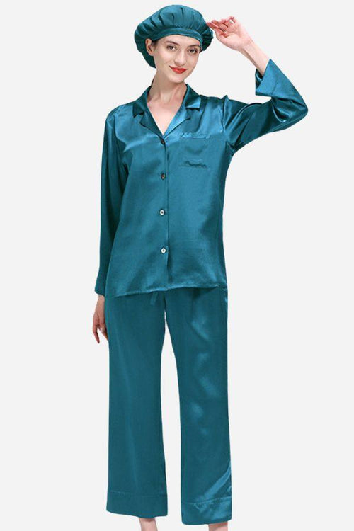 Woman wearing teal Classic Mulberry Silk Pajama Set with matching sleep cap