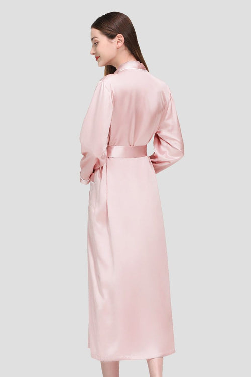 Woman wearing a pink 100% mulberry silk belted classy nightgown from the back