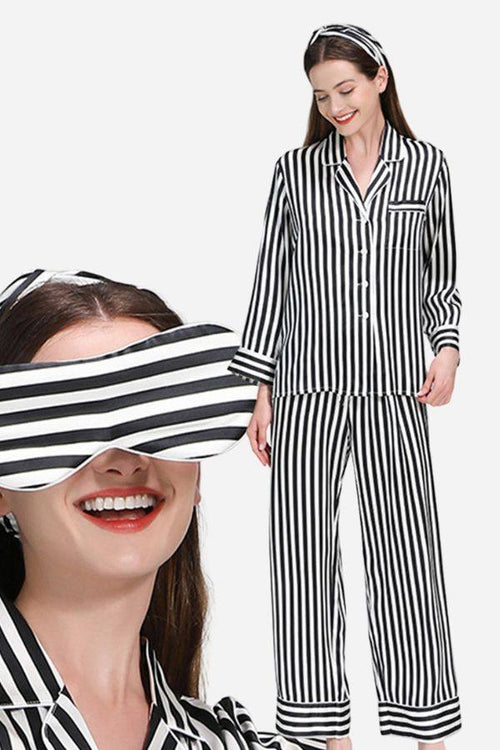 Woman wearing 100% mulberry silk black and white striped long sleeve pajama set with matching headband and eye mask