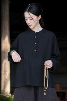 Woman wearing black Ramie Linen & Cotton loose blouse with wooden buttons and side pocket