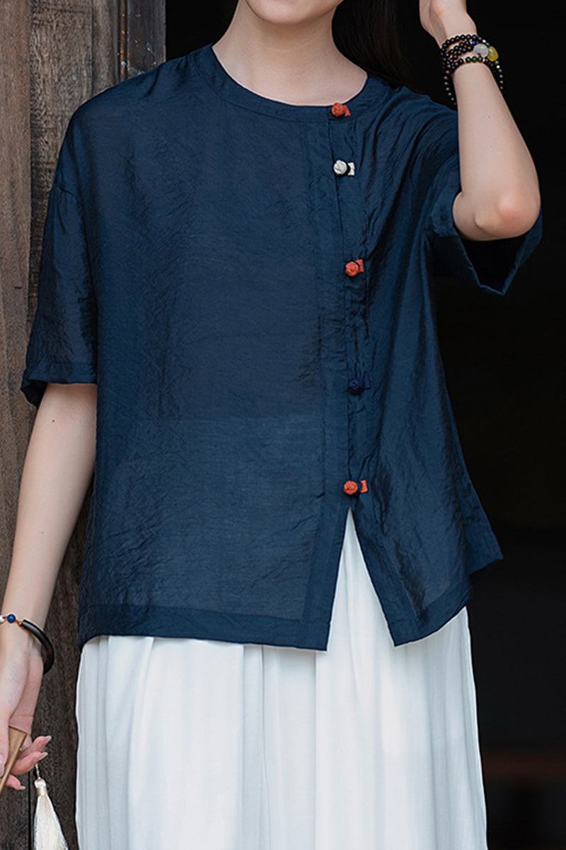 Oversized navy regenerated cellulose blouse with asymmetrical buttons, wrinkle-resistant and breathable fabric.