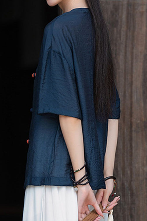 Oversized navy regenerated cellulose blouse with asymmetrical buttons and wrinkle-resistant fabric