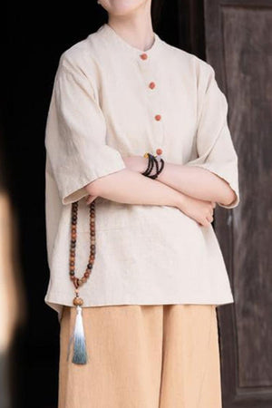 One size fits all ramie linen and cotton shirt with short sleeves and wooden buttons, styled with neutral pants and accessories