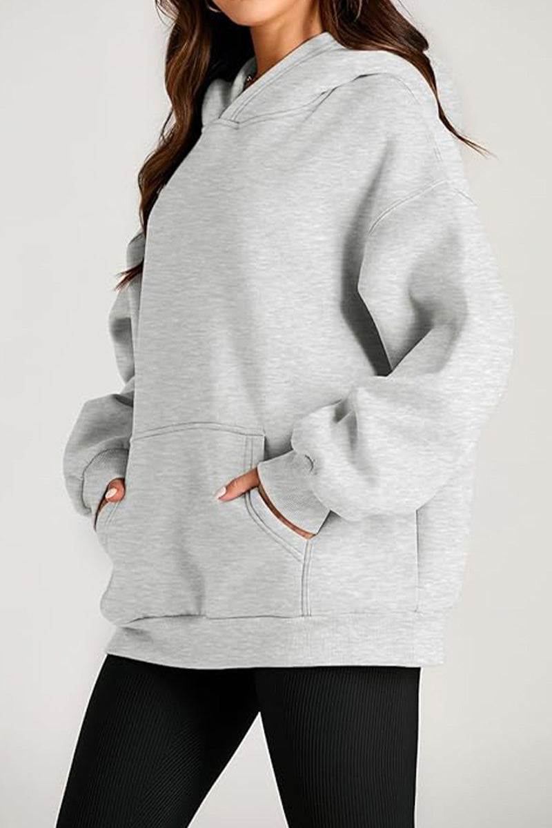 Oversized fleece-lined hoodie in light gray with front pocket and relaxed fit for cozy warmth and travel comfort