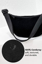 Black corduroy shoulder bag with adjustable strap and zip closure, soft textured lightweight design for everyday use