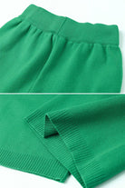 Close-up of green knitted turtleneck two-piece set fabric and ribbed cuffs