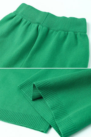Close-up of green knitted turtleneck two-piece set fabric and ribbed cuffs