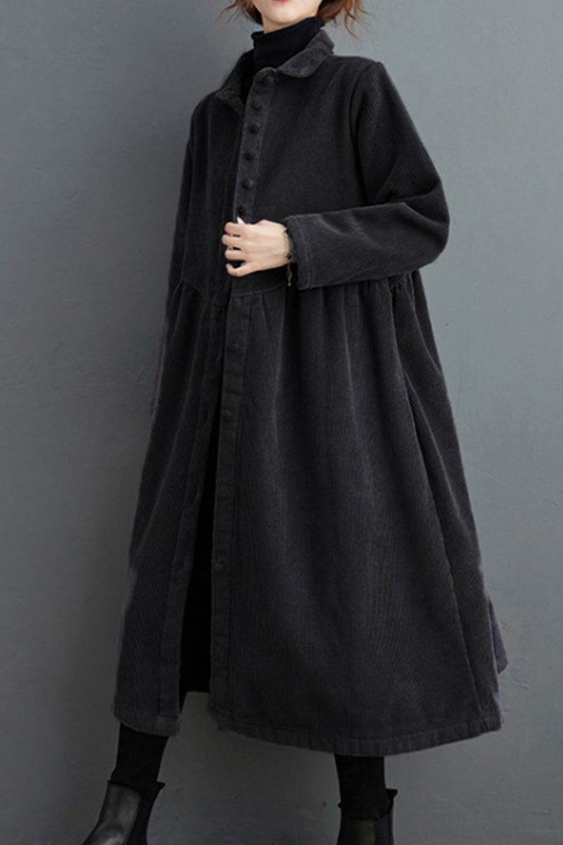 Black oversized vintage corduroy coat with button-up front and long sleeves worn with black turtleneck and boots