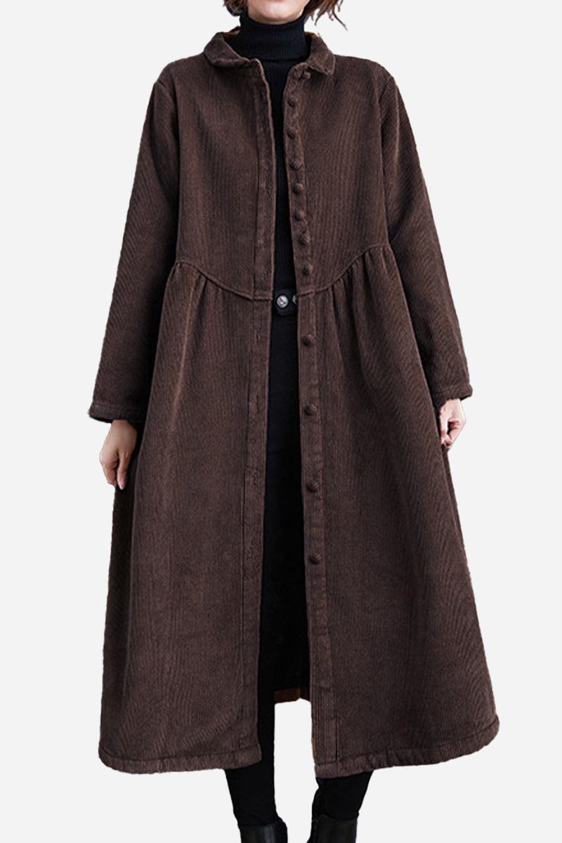 Oversized vintage brown corduroy coat with long sleeves and button closure, worn over black outfit