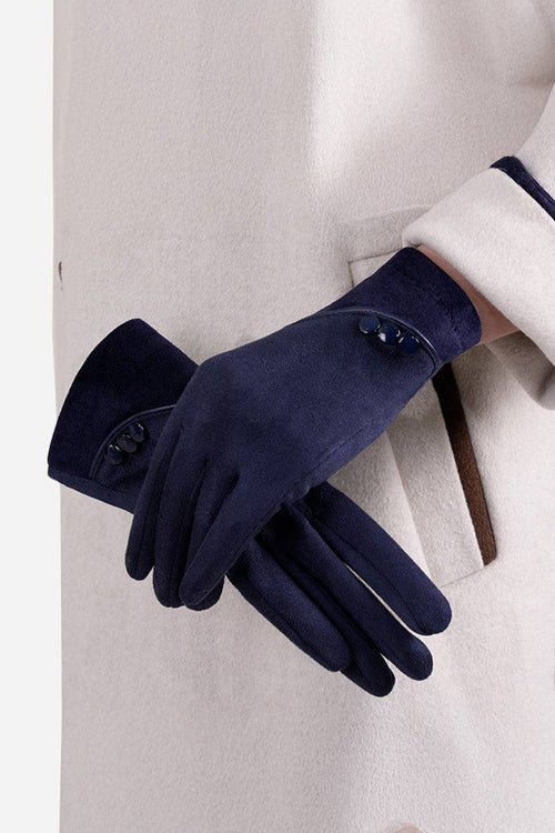 Navy blue SmartTouch suede gloves with touchscreen fingertips and button details on wrist worn with beige coat