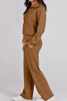 Woman wearing brown Loungewear Buttersoft Tracksuit Set with hoodie and relaxed fit pants.
