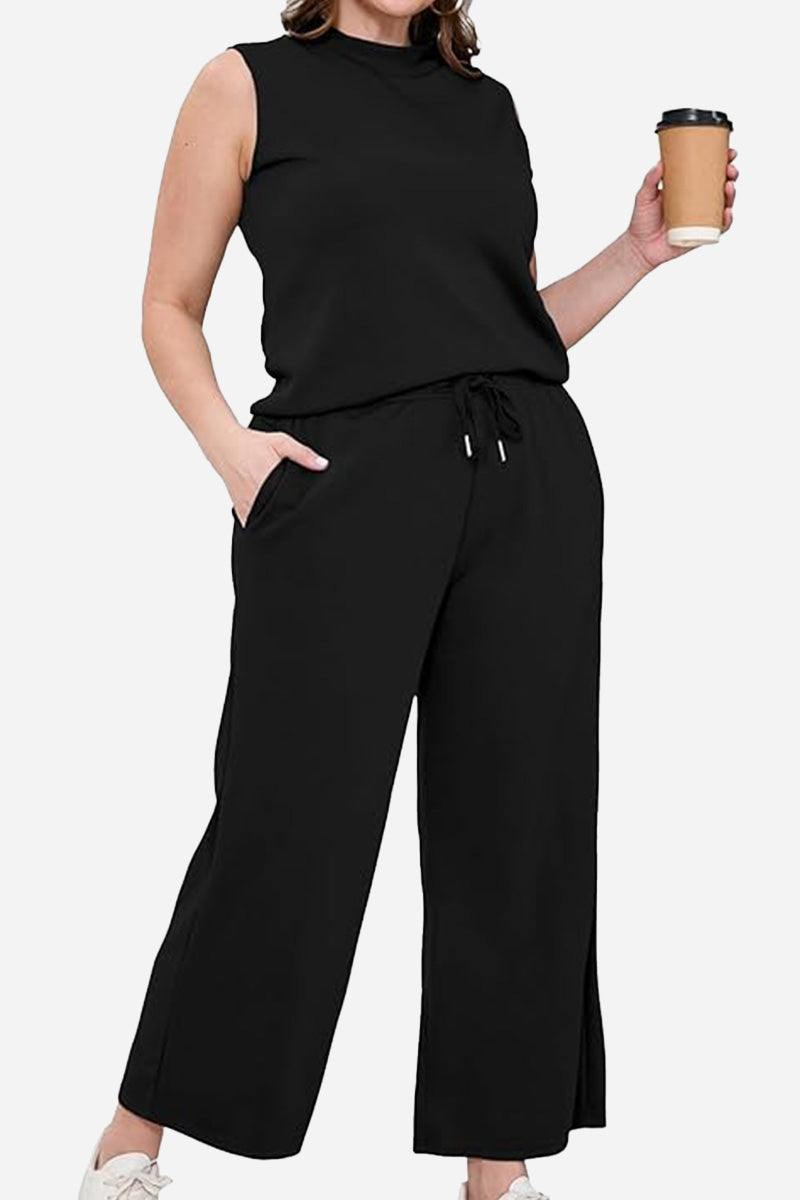 Cotton Chic Sleeveless black two-piece set with relaxed fit and pockets, perfect for travel and casual elegance