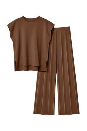 First Class Travel brown two-piece set with pleated wide-leg pants and a loose top for comfortable, wrinkle-resistant elegance.