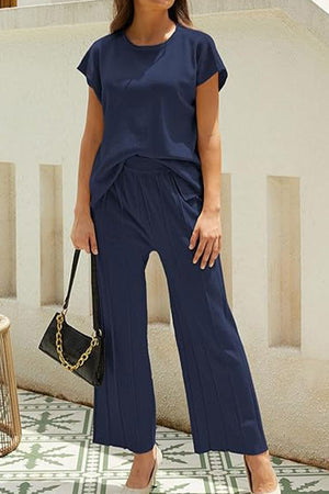 First Class Travel two-piece navy set with pleated wide-leg pants and short-sleeve top for wrinkle-resistant comfort and versatile elegance