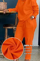 All-Day Comfort 2-Piece Outfit Set in bright orange, smooth wrinkle-resistant polyester fabric, relaxed fit with long-sleeve top and pants.