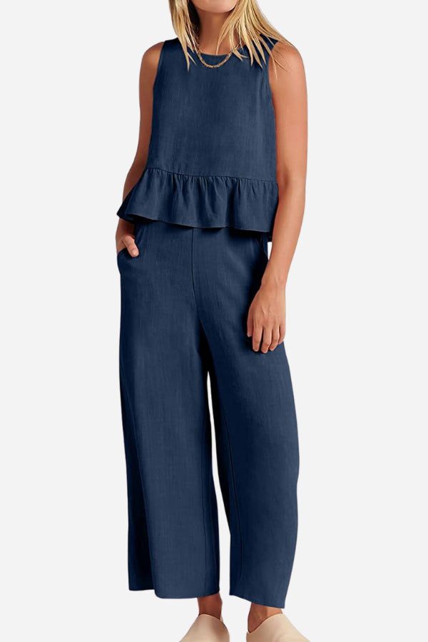 Woman wearing navy blue linen-like feel set with sleeveless ruffle top and wide-leg pants