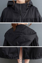 black oversized all-weather water-resistant windbreaker with hood and front zipper closure