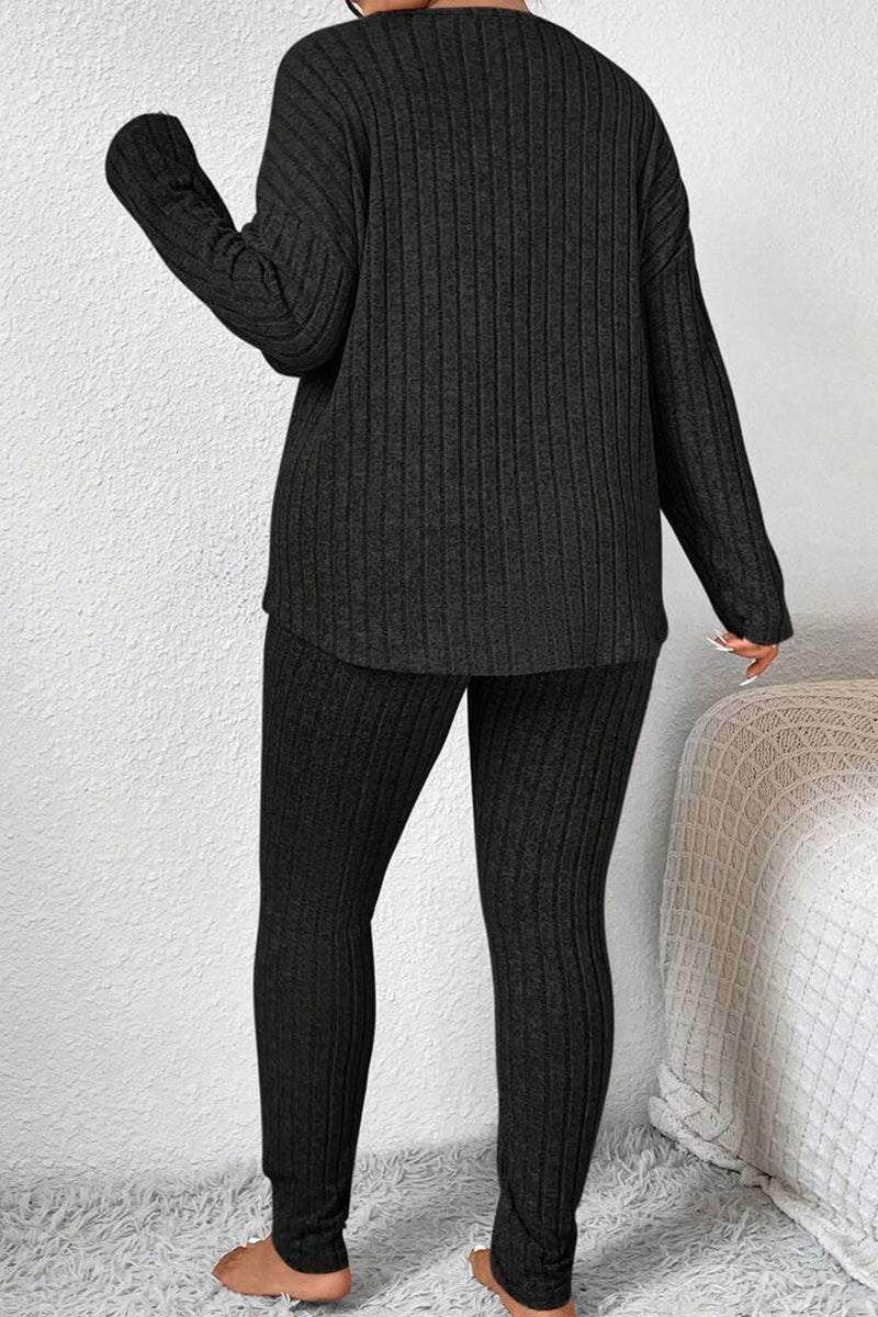 Back view of a woman wearing a black Body Confident Oversized Knit two-piece cozy knit outfit.