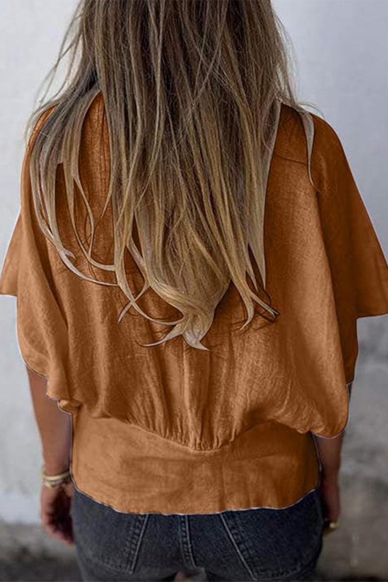 back view of woman wearing brown pure linen short-sleeve blouse with relaxed fit and natural wrinkles