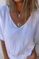 White pure linen short-sleeve blouse with V-neck and relaxed fit