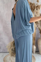 light blue two-piece pantsuit with V-neck and flowy short sleeves on model