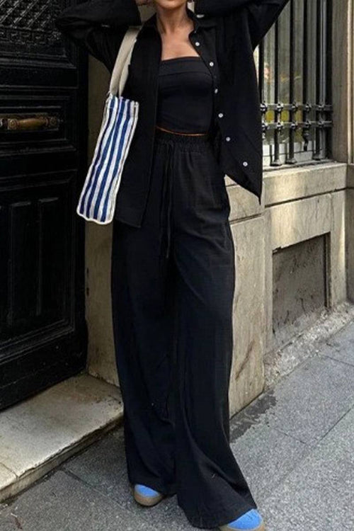 woman wearing black 100% cotton double comfort two-piece set with relaxed fit and blue shoes standing outdoors