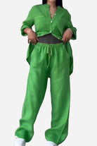 Woman wearing a bright green 100% cotton double comfort two-piece set with relaxed fit pants and matching button-up top.