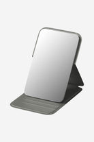 Compact Travel Pocket Mirror with durable PU leather case in grey, lightweight and portable for on-the-go touch-ups.