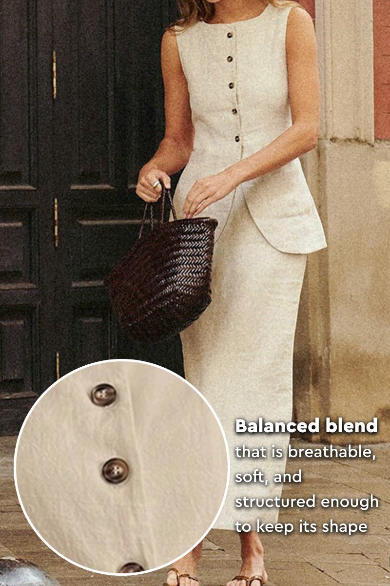 Woman wearing sleeveless cotton-linen blend vest and high-waisted skirt two-piece set with button details and holding a woven bag