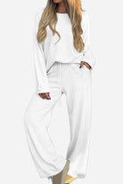 White relaxed fit two-piece set with wide-leg pants and button-cuff top designed for comfortable, wrinkle-resistant travel wear