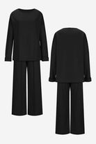Black comfortable travel-ready two-piece set with relaxed fit long-sleeve top and wide-leg pants, wrinkle-resistant fabric.