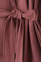 Close-up of dusty rose fabric belt tied in a knot from the Mix-Match Lounge-to-Travel Set
