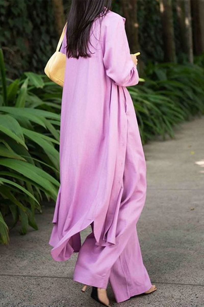 Woman wearing a soft pink relaxed fit shirt and trouser three-piece set walking outdoors