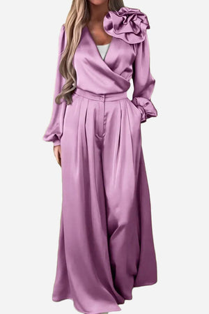 Elegant lavender satin two-piece set with statement shoulder blouse and flowing palazzo pants