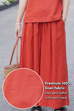 Woman wearing premium 100% linen wide-leg pants in burnt orange with elastic waist and side stitching detail