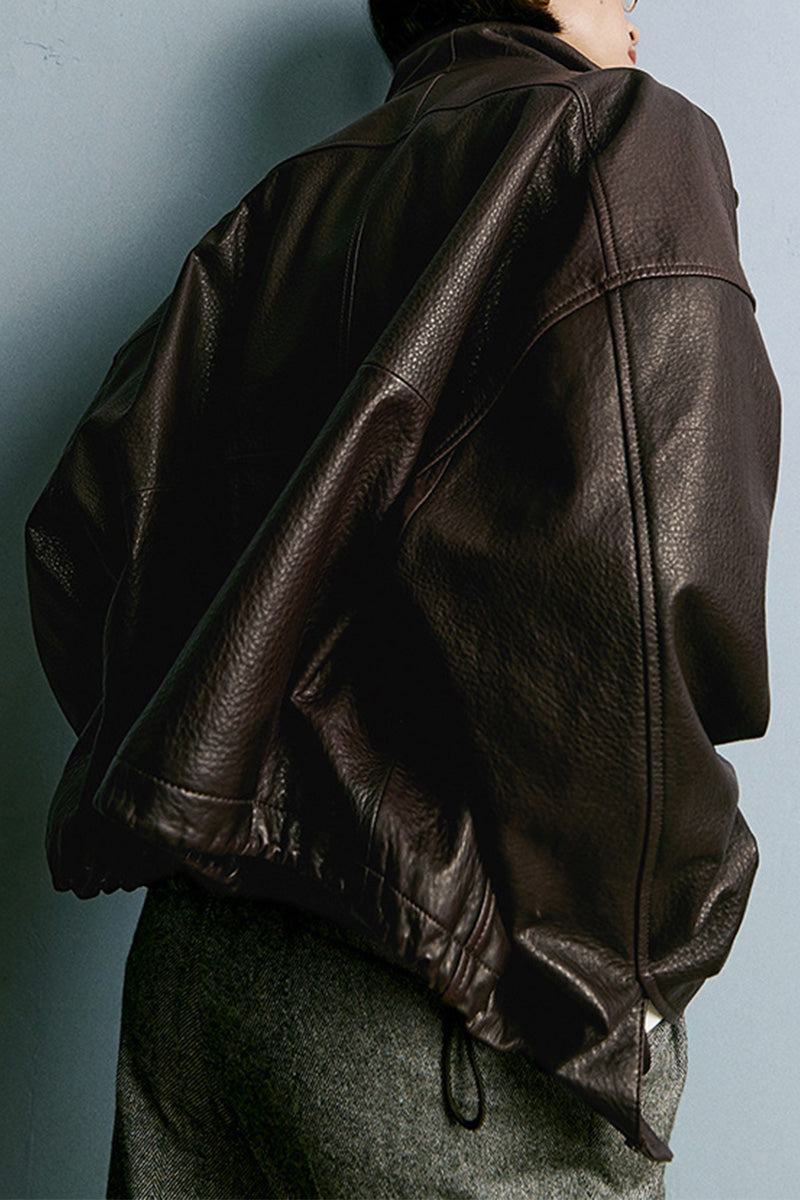 Back view of black genuine sheepskin leather jacket with soft, glossy texture and relaxed fit.
