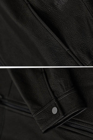 Close-up of black sheepskin leather jacket texture and sleeve detail with snap button, showcasing genuine soft leather material.