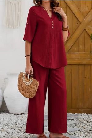 Red wrinkle-free wide leg pants and matching button-front top travel set with 3/4 sleeves and casual fit.
