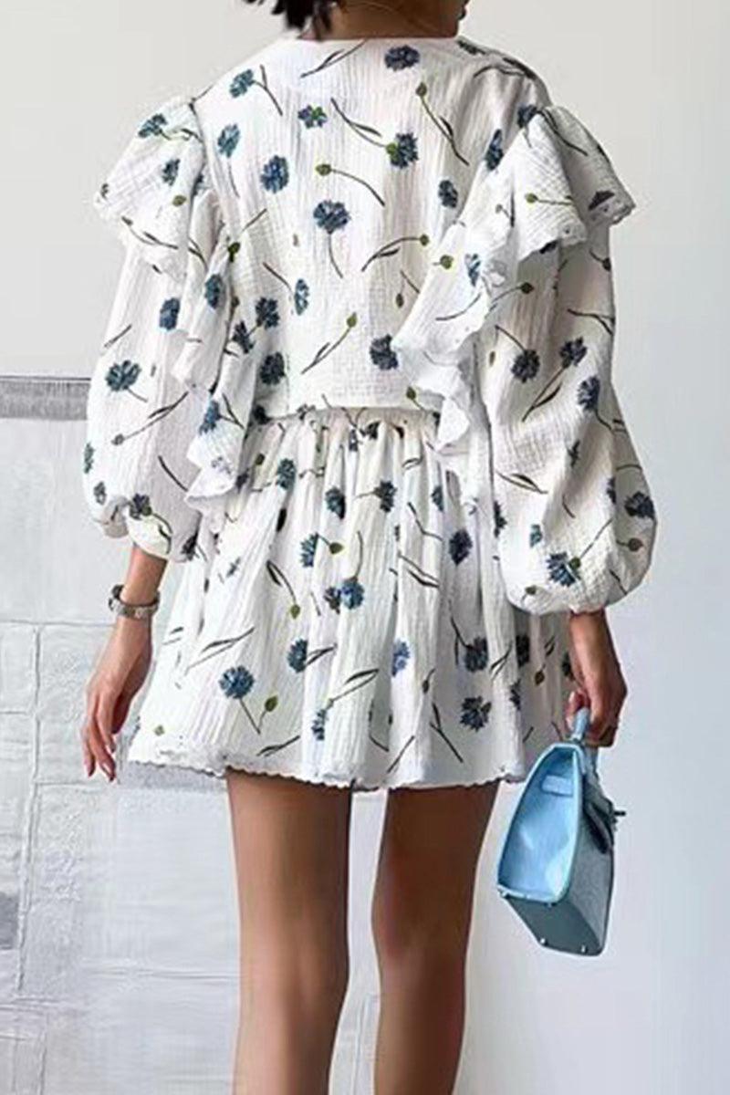Back view of woman wearing Sweet Countryside 100% cotton ruffled two-piece set with floral print and puff sleeves, holding blue handbag