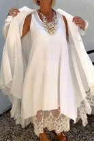 Woman wearing Villa Breeze Dress and Cardigan Set in white with lace details and layered necklace