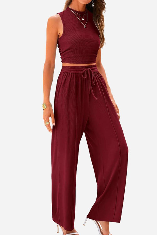 Woman wearing burgundy Stroll & Hangout Ribbed Knit two-piece set with sleeveless crop top and wide-leg pants in stylish casual outfit