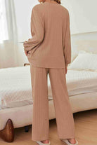 Woman wearing Desert Bloom Ribbed Comfort Set in soft ribbed fabric with relaxed fit and wide-leg pants in beige tone