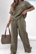 Olive green breathable two-piece set with floral embroidery, loose fit top and wide-leg pants.