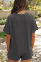 Woman wearing a black striped relaxed-fit top and shorts set for slow mornings outdoors