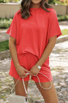 Woman wearing red short sleeve relaxed fit top and matching shorts set for slow mornings outdoors