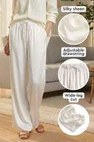 Subtle Moves Silk Wide Leg Trousers in white with silky sheen, adjustable drawstring waist, and wide-leg cut design.