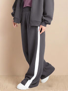 Two-piece easy airport lounge set with zip-front jacket and wide-leg pants in soft cotton-blend fabric designed for travel comfort and wrinkle resistance